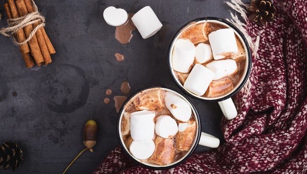 Hot chocolate served in vintage mugs with marshmallows