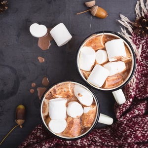 Hot chocolate served in vintage mugs with marshmallows