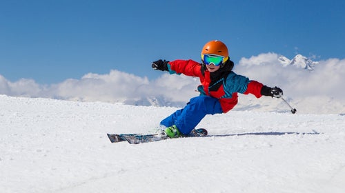 Kid carving on skis