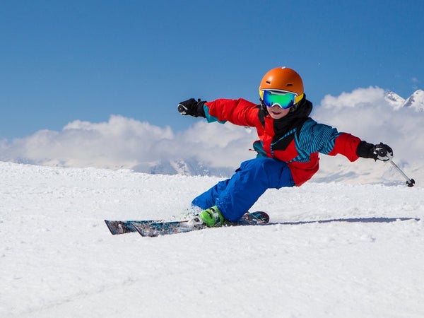 Kid carving on skis