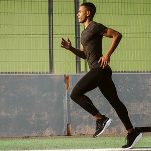 athlete running on track