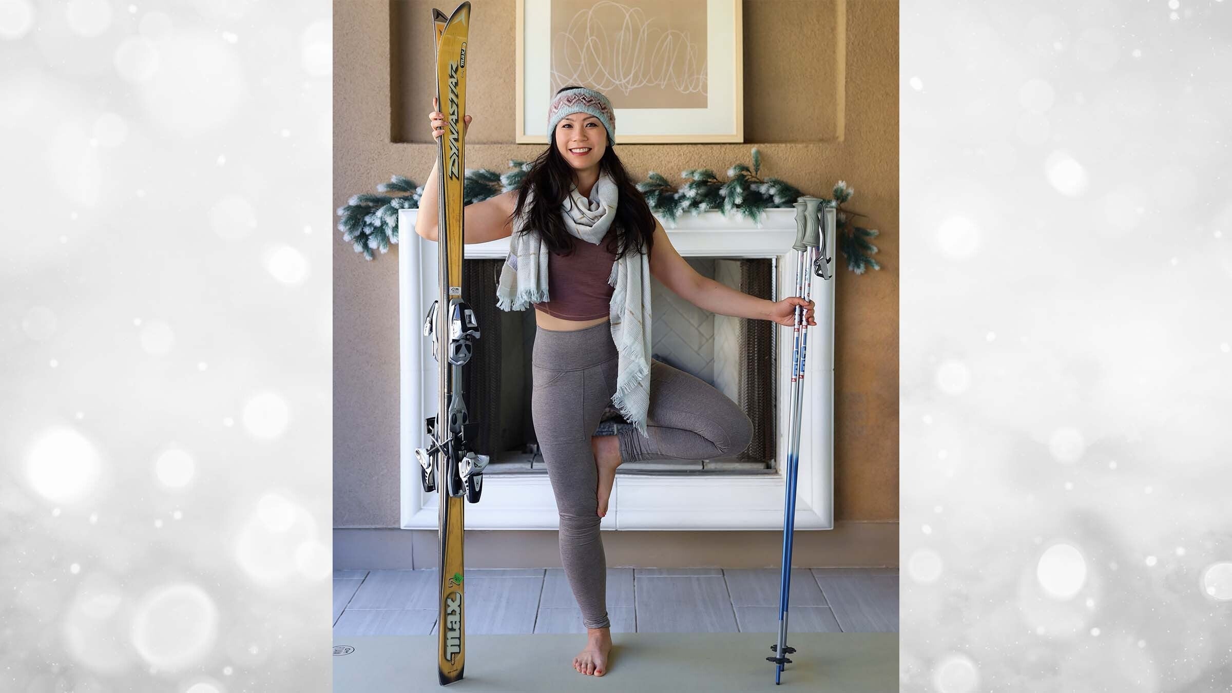 Ingrid Yang in front of fireplace with skis