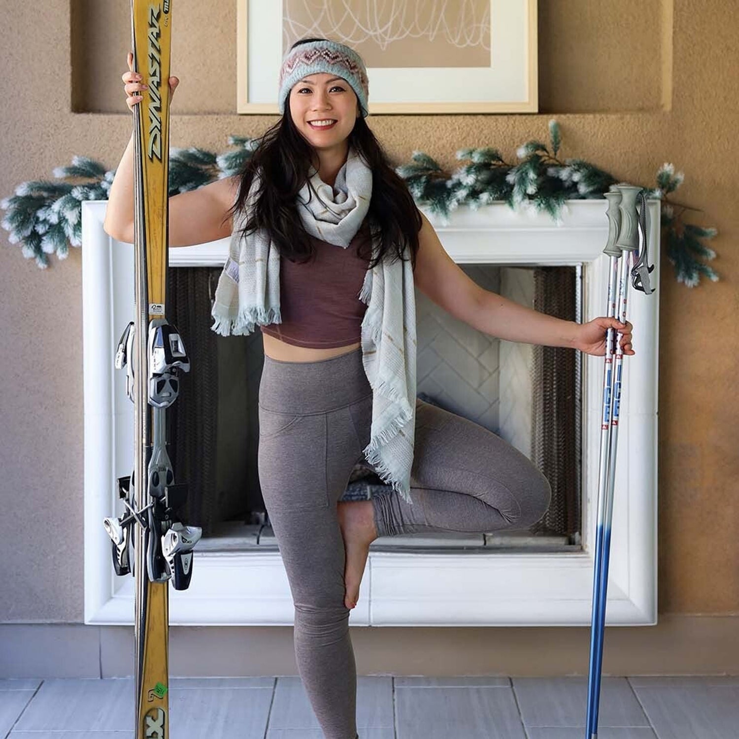 Ingrid Yang in front of fireplace with skis