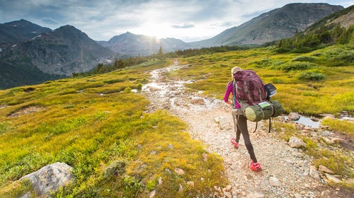 Woman backpacking in the Indian Peaks wilderness on Arapahoe pass trail in Colorado.