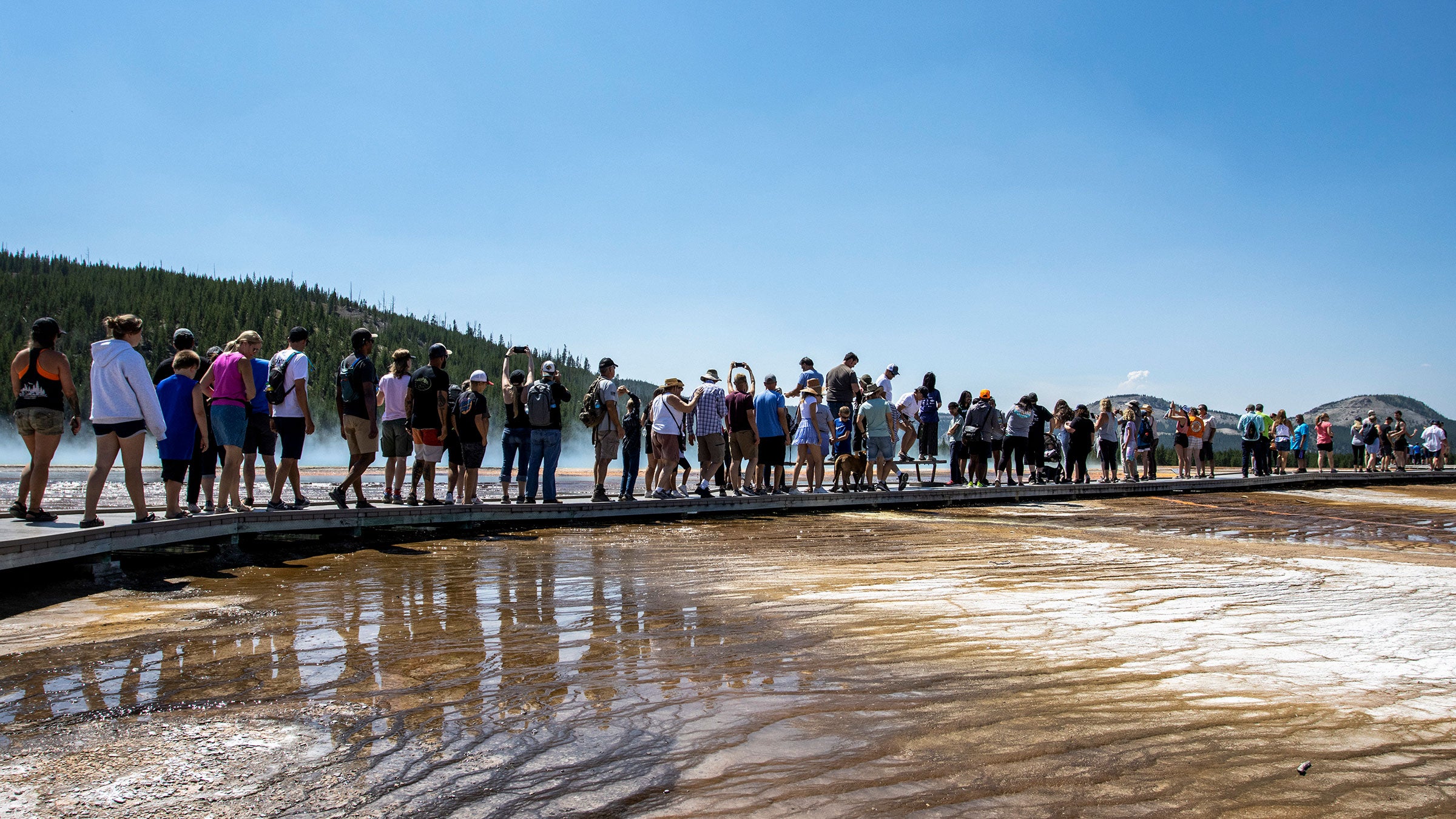 Tourists crowd in to the Midway Geyser Basin July 14, 2021 at Yellowstone National Park, Wyoming. 