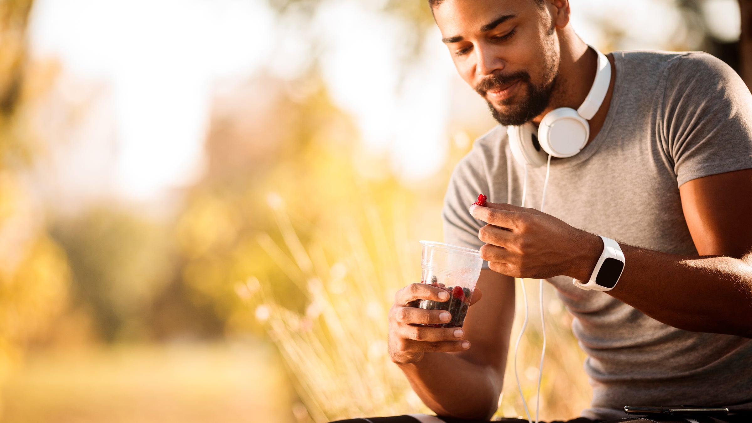 Athlete eating berries while resting from exercise