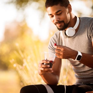 Athlete eating berries while resting from exercise