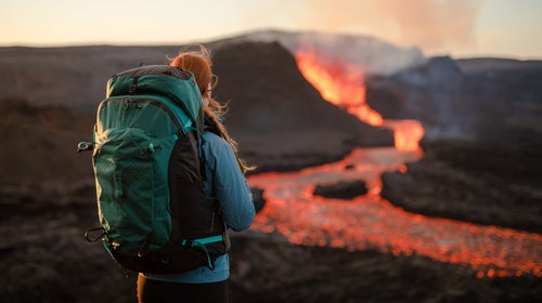 Hiker wearing Osprey UNLTD near a volcano in Iceland