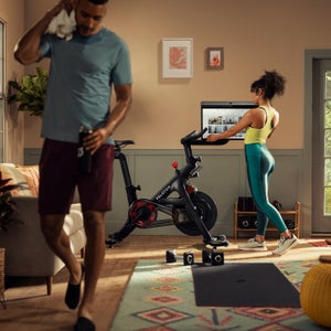 Two people use Peloton equipment