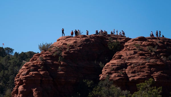 Tourists gather at the Airport Vortex one of many spiritual hot spots in and around the desert town of Sedona Arizona.
