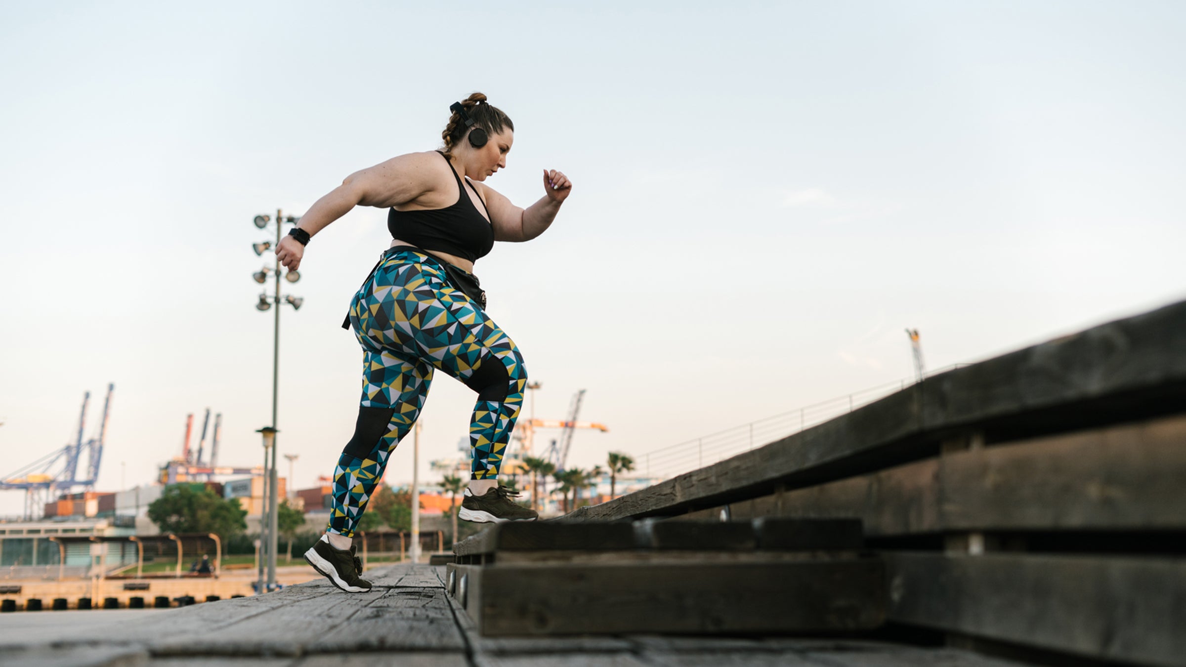 woman in sportswear climbing steps