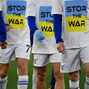 Lazio team players wear a 'Stop the war' T-shirts referring to Russia's invasion of the Ukraine as they arrive to warm-up prior to the Italian Serie A football match between Lazio and Napoli at the Olympic stadium