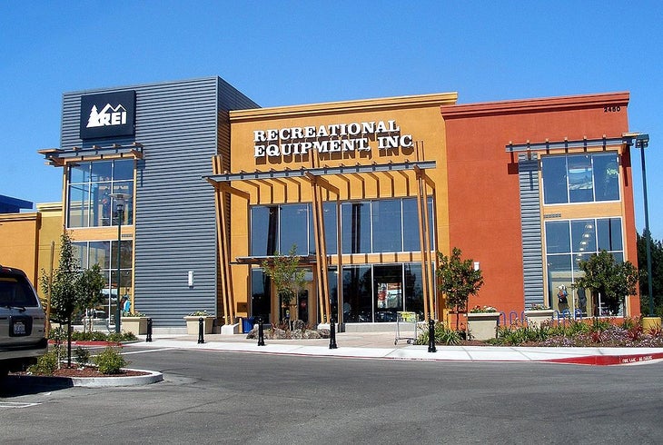 REI storefront on a sunny day.