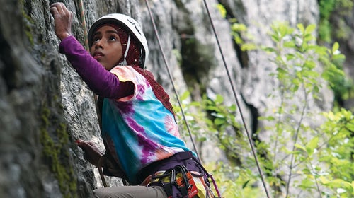 A young girl rock climbing