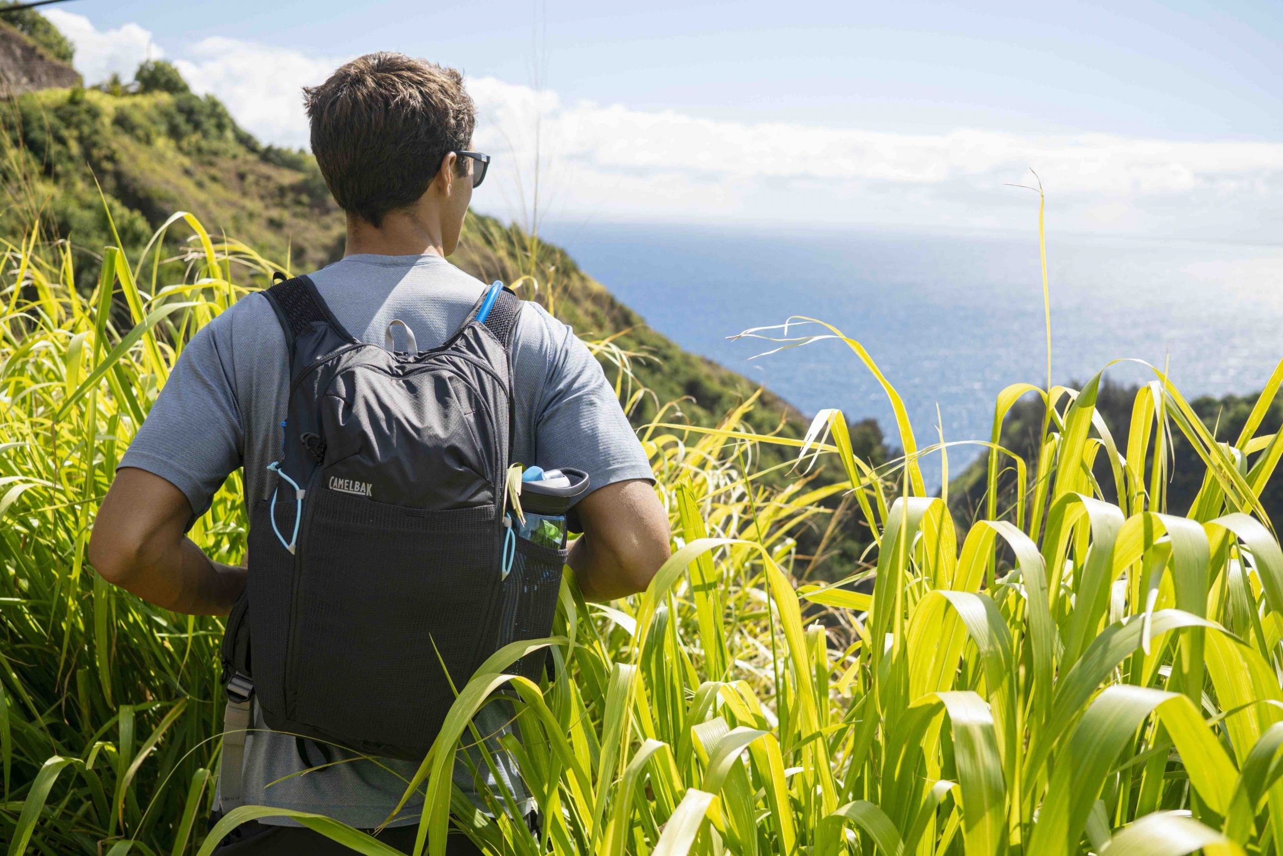 Man wearing backpack looking at the ocean