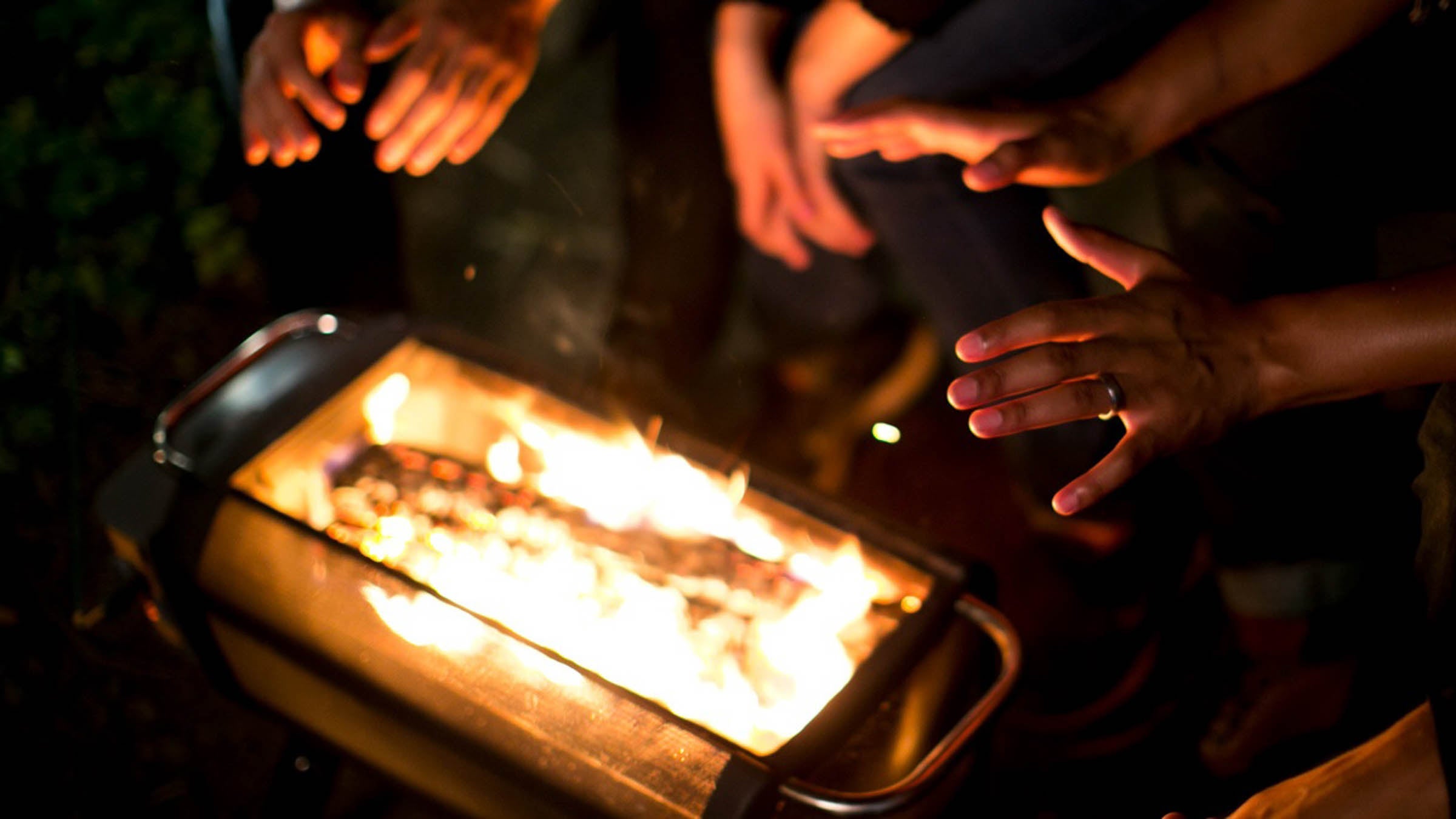 Hands warming by a fire