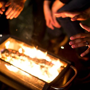 Hands warming by a fire