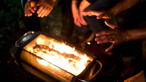 Hands warming by a fire