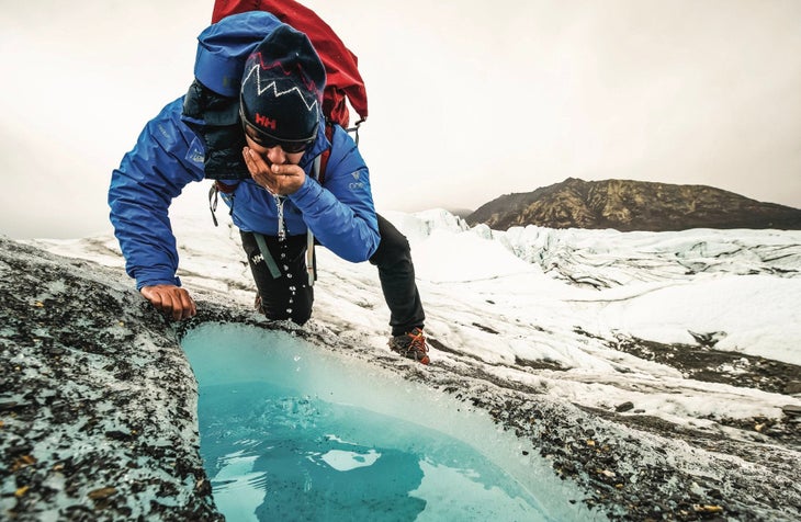 Man drinking from arctic pool