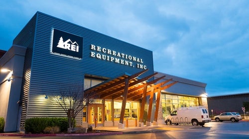 REI storefront at dusk