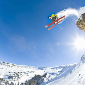 Freestyle skier jumping off cliff
