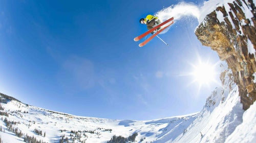 Freestyle skier jumping off cliff