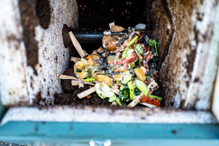 Vegetable and paper scraps inside a compost bin |Grundens compostable packaging