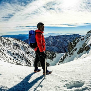 Andrew King on top of a snowy mountain