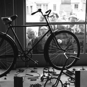 German men and boys peer in the window at the merchandise in a bicycle shop in Berlin in 1948