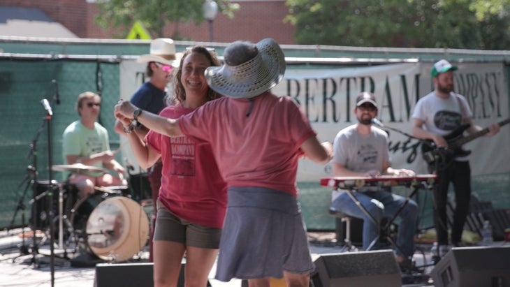 Betsy Audrey Dance 3 Two women dancing in front of a live band