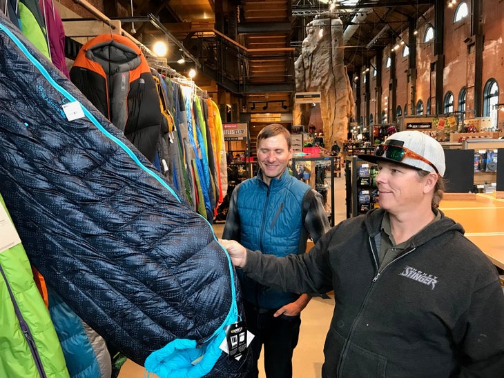 big agnes retail sleeping bag employee Customer looking at Big Agnes sleeping bag in retail store