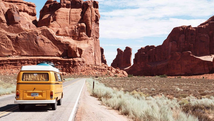 Van driving into the distance in Moab