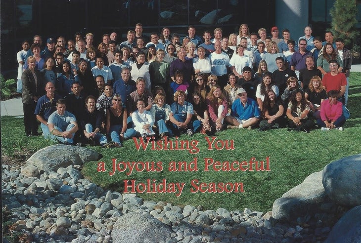 Group of employees on grass with words Wishing You a Joyous and Peaceful Holiday Season | Eagle Creek should not die