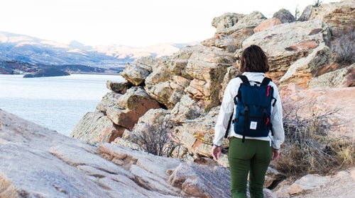 Woman hiking along a rocky coast