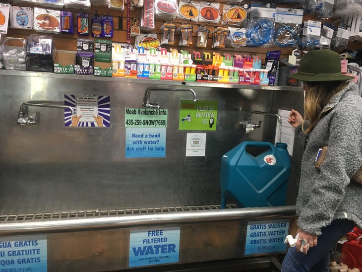Gearheads Outdoor Store water station Kali Platt fills a water jug at Gearheads Outdoor Store