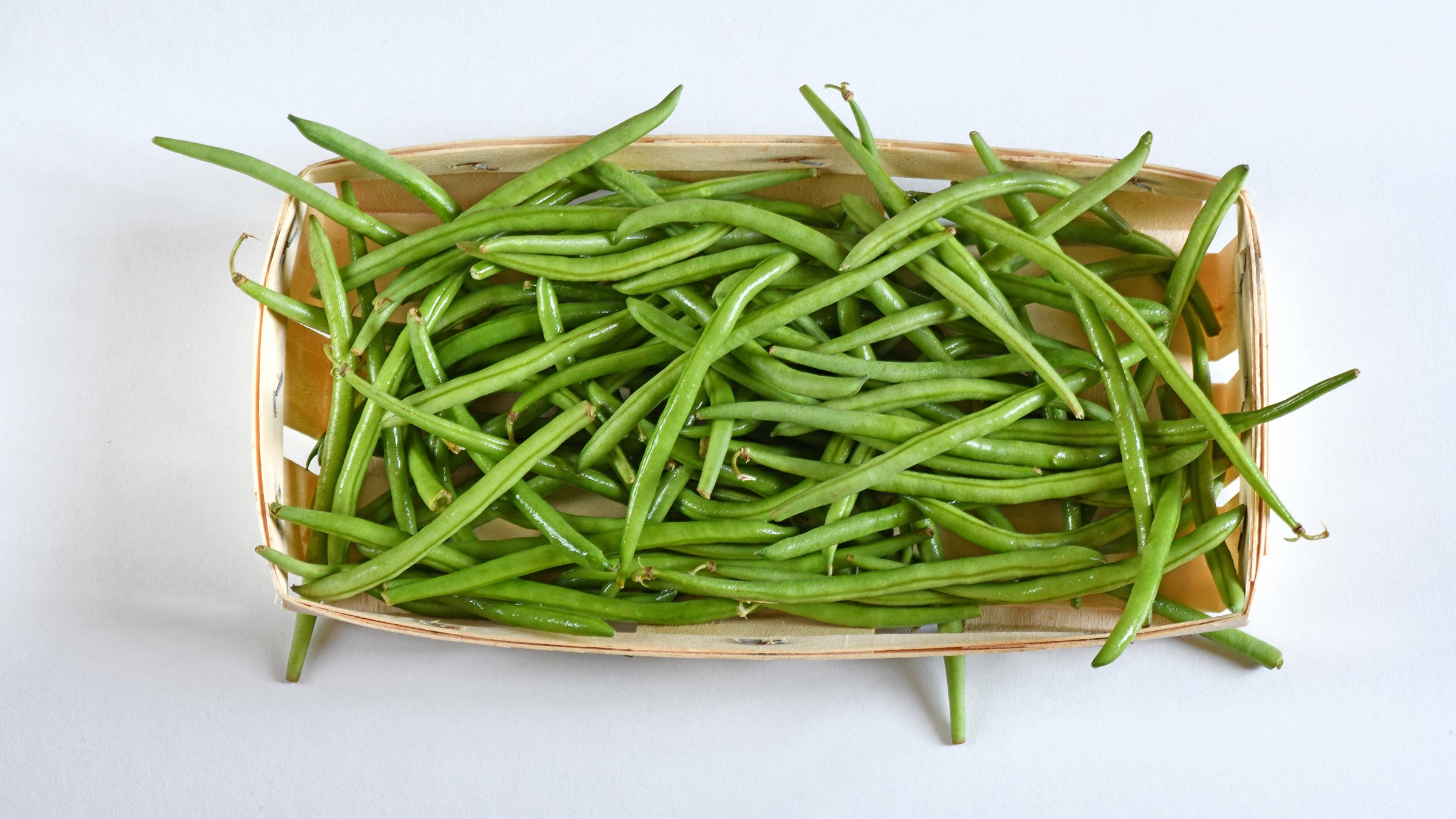 Close-up of beans in bowl on white background