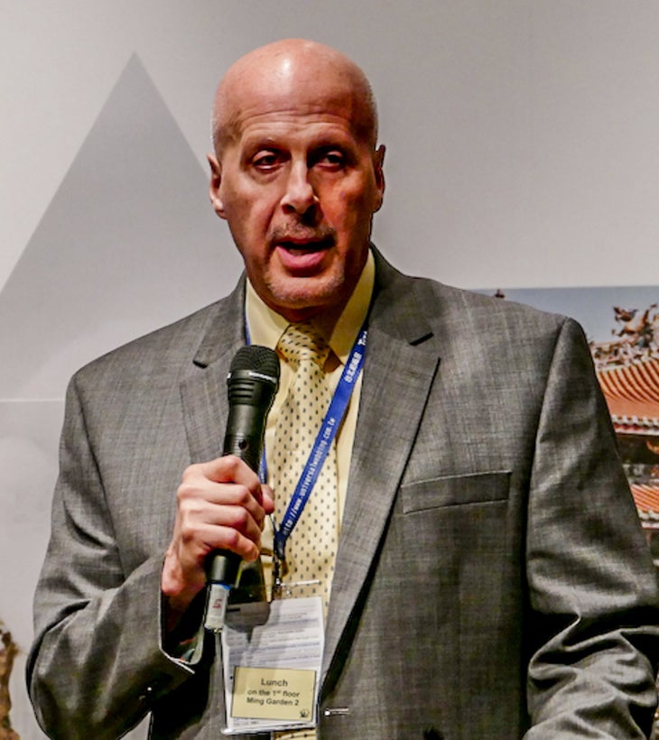 GTI-head shot-selwyn Green Theme International | Gary Selwyn speaking into microphone