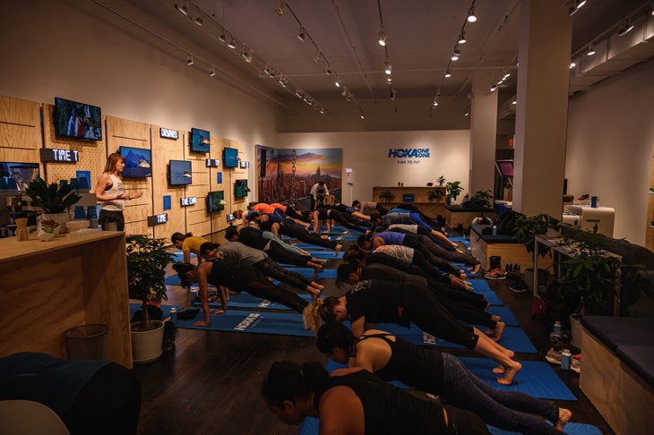 People doing yoga in HOKA ONE ONE pop-up during the NYC marathon 2019