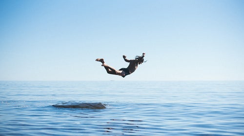 A man dives from a rock at Cutface Creek Waydeside in Minnesota after driving along the north shore of Lake Superior.