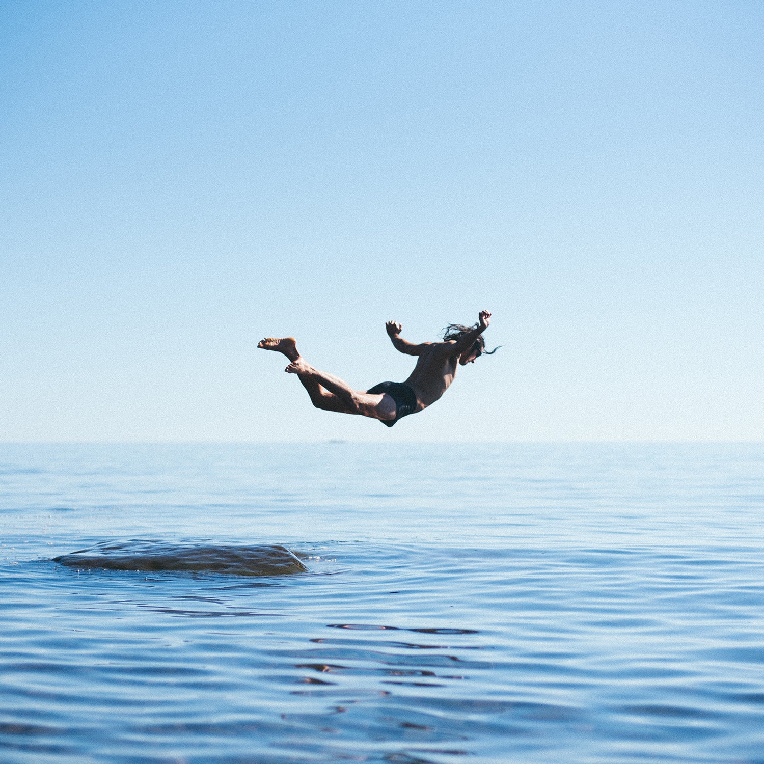 A man dives from a rock at Cutface Creek Waydeside in Minnesota after driving along the north shore of Lake Superior.