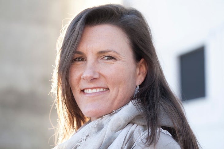 "Smiling woman with long brown hair"