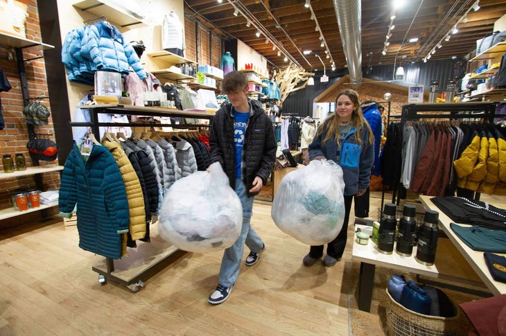 Two people carrying bags through a retail store | polybag pilot