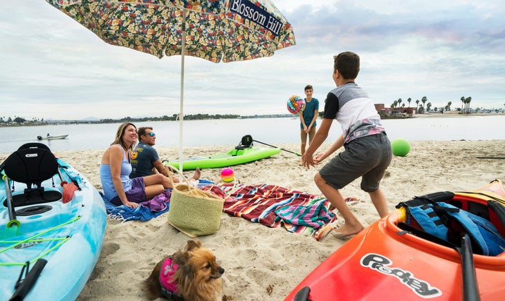 PR_17_18_Family_and_Volleyball_Beach_Prodigy_XS_Tribe_HiLife Family playing on beach with kids prodigy kayak | family paddlesports