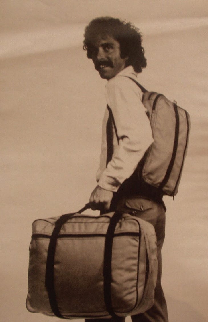 Old catalog photo of a man carrying luggage on white backgound | Eagle Creek should not die