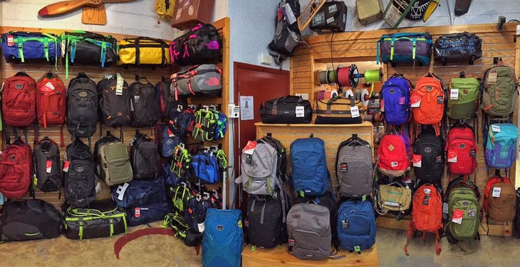 all types of backpacks hang on the walls of rusted moon outfitters