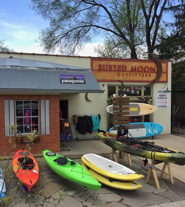 Kayaks in front of Rusted Moon Outfitters