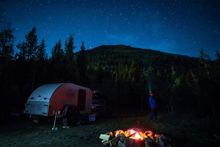 rv at night with campfire RV at night with campfire