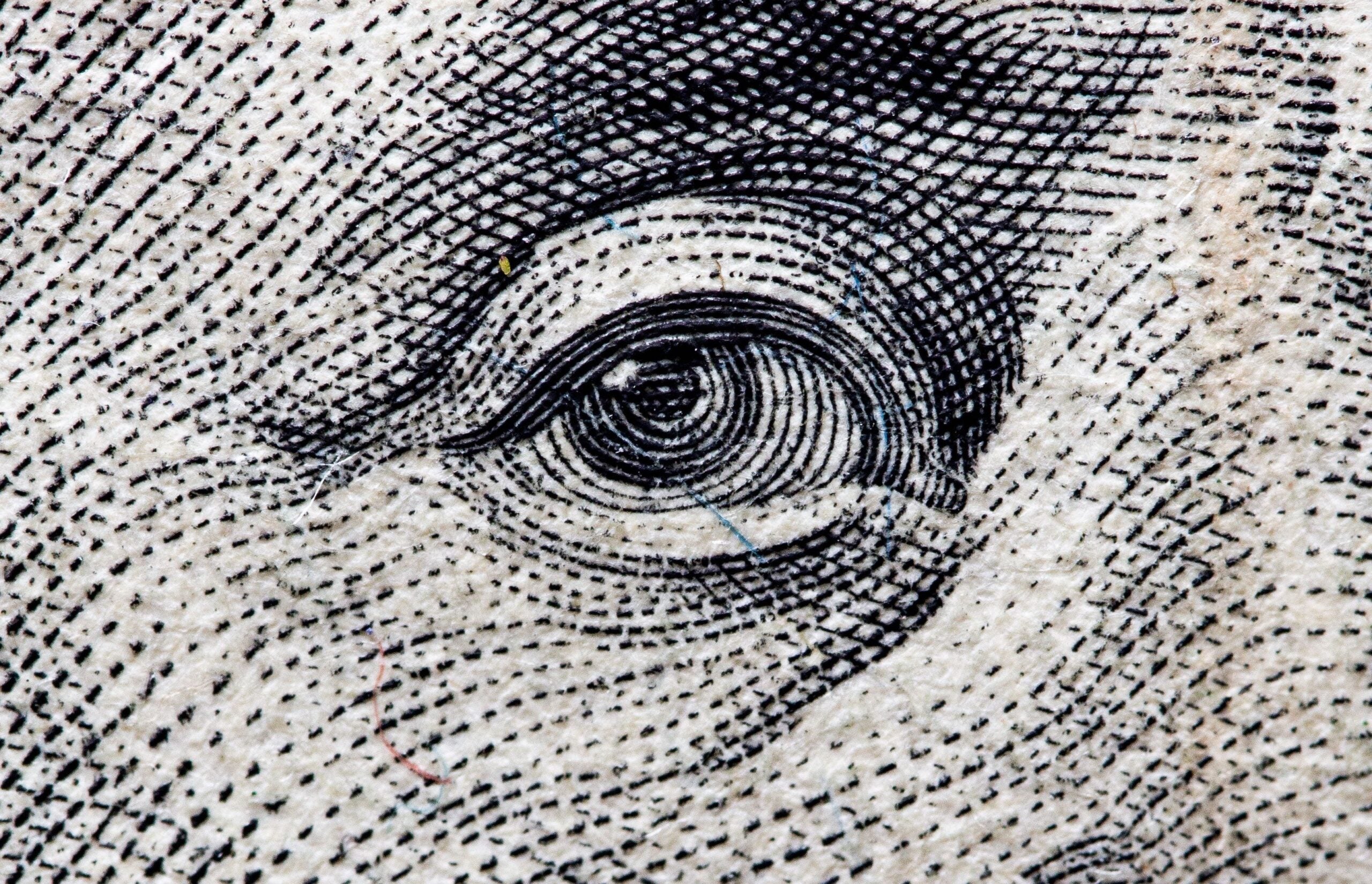 Close-up of Ben Franklin's eye on one hundred dollar bill