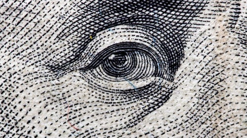 Close-up of Ben Franklin's eye on one hundred dollar bill