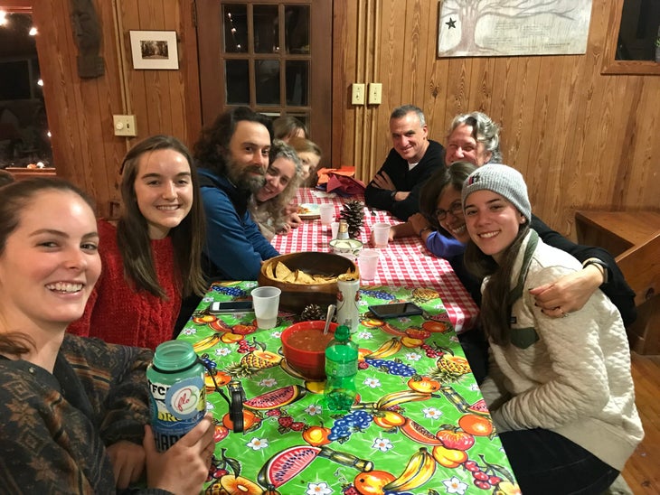 Employees at Townsend Bertram & Company enjoy chips and salsa around a table at a staff party